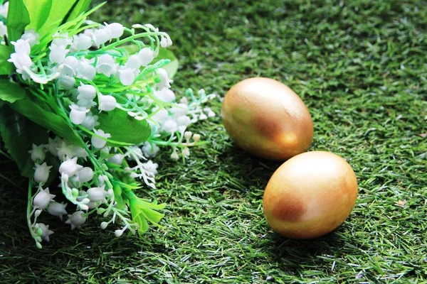 Painted with Golden eggs on green grass