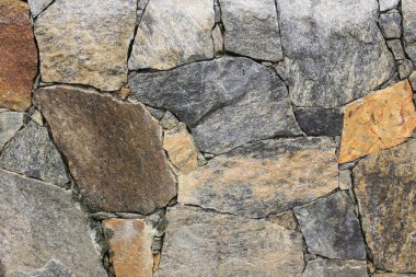 Bir duvara yığılmış çok renkli kayalar dokusu