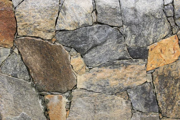 Textura de rocas multicolores apiladas en una pared — Foto de Stock