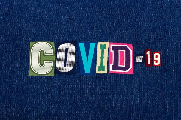 CORONAVIRUS COVID-19 text word collage, worldwide pandemic flu virus information, colorful letters on blue denim, horizontal aspect