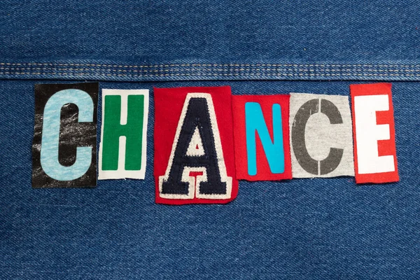 Bright CHANCE word collage from cut out tee shirt letters on denim, personal growth, horizontal aspect
