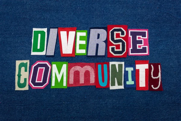 DIVERSE COMMUNITY text word collage, brightly colored fabric on blue denim, group diversity concept, horizontal aspect