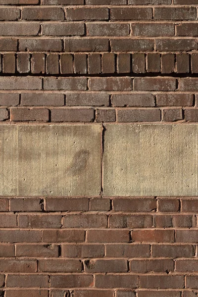 Background of old brick wall with layer of textured concrete, vertical aspect