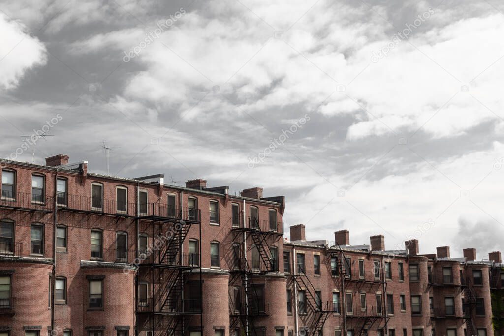 Bleak gray sky over old rowhouse, urban city dwellings, horizontal aspect
