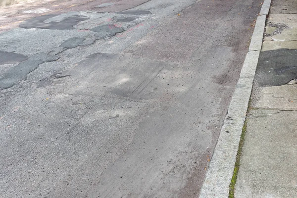 Straat Trottoir Afbrokkelende Verval Zwaar Gepatchte Asfaltweg Horizontaal Aspect — Stockfoto