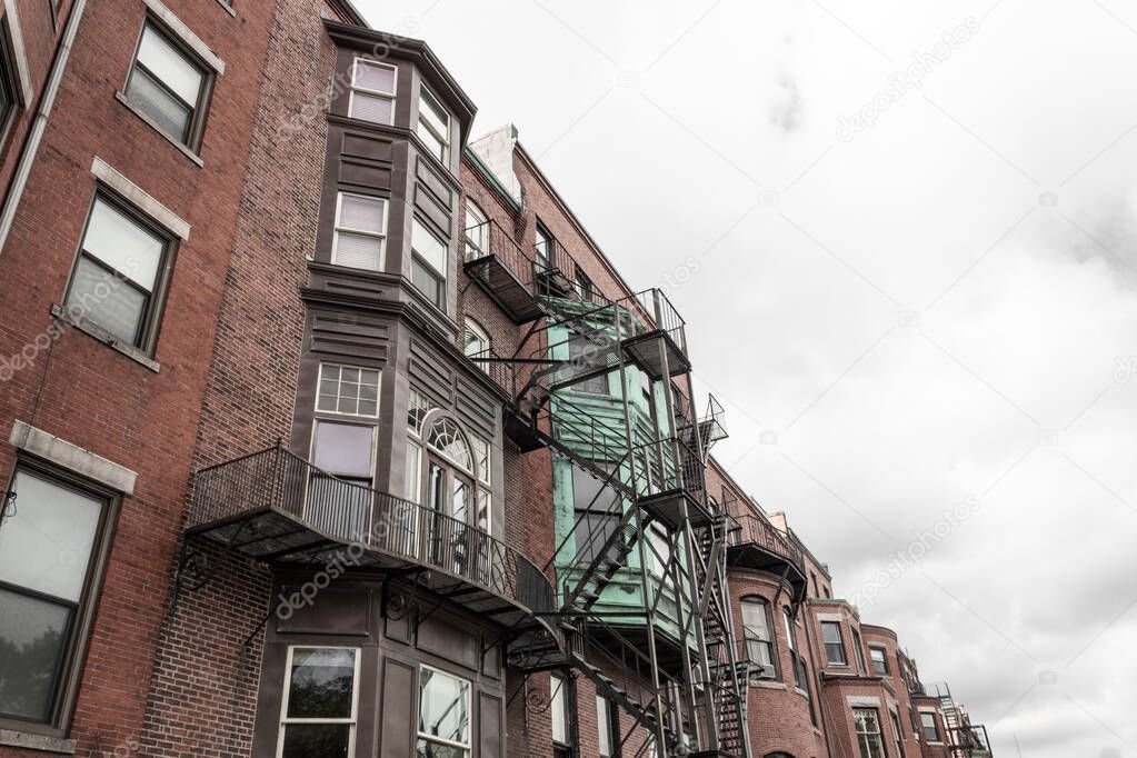 A variety of brick and metal finishes on a rear view of old apartment buildings, urban housing, horizontal aspect