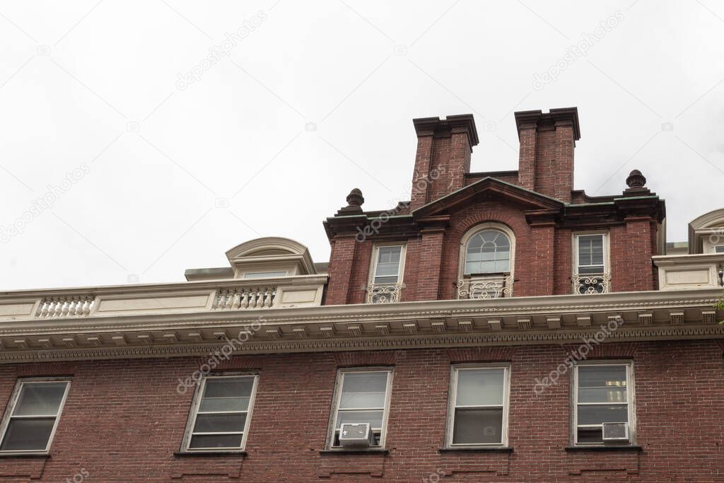 Old brick residential apartment building with roofline moulding details, horizontal aspect