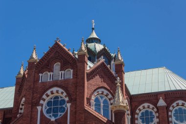 Kırmızı tuğla ve beyaz gotik diriliş kilisesinin dış detayları, bulutsuz mavi gökyüzü, yatay görünüm