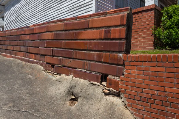 Old retaining walls of brick, hollow red ceramic square tube, and concrete, horizontal aspect
