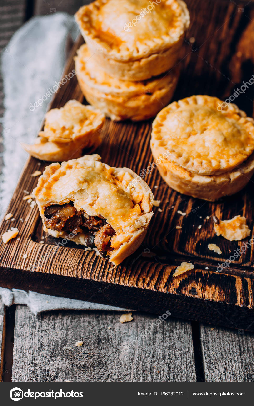 Australian meat pies on wooden table Stock Photo by ©AnikonaAnn 166782012