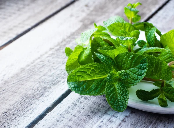 Green fresh mint on the wooden table — Stock Photo, Image