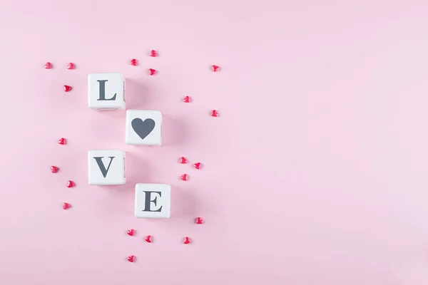 Love message written in white wooden blocks on pink background. — 스톡 사진