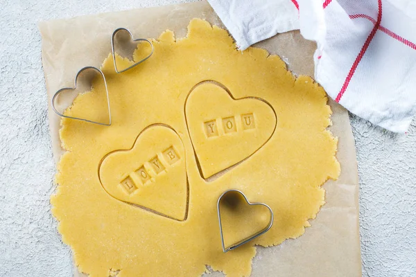 Bakery Valentine's Day Concept. Making homemade heart shaped cookies from shortbread raw dough. — 스톡 사진