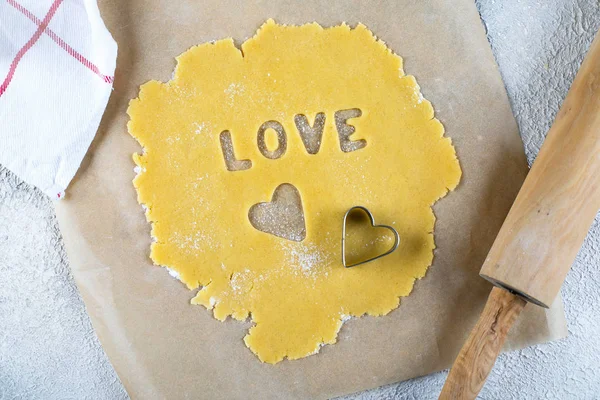 Bakery Valentine's Day Concept. Be mine text. Making homemade heart shaped cookies from shortbread raw dough. Top view — 스톡 사진