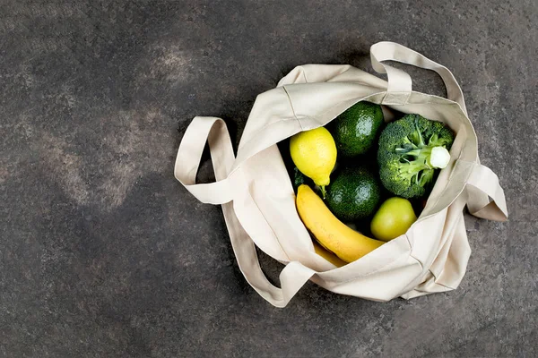 어두운 콘크리트 테이블 배경에 야채와 노란색 쇼핑백 낭비없는 친화적 — 스톡 사진
