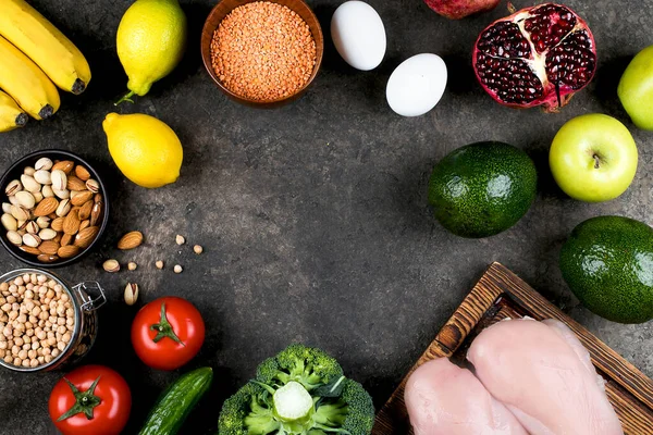 Healthy Nutrition Food Dieting Concept. Meat, vegetables, fruits and bean product on slate table background. Top view, flat lay, copy space. Food Frame.