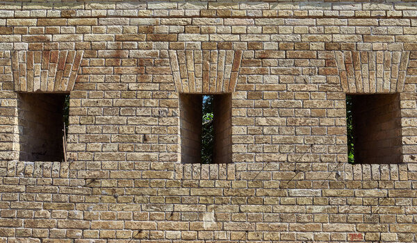Fragment of a brick wall of fortifications with small loopholes 