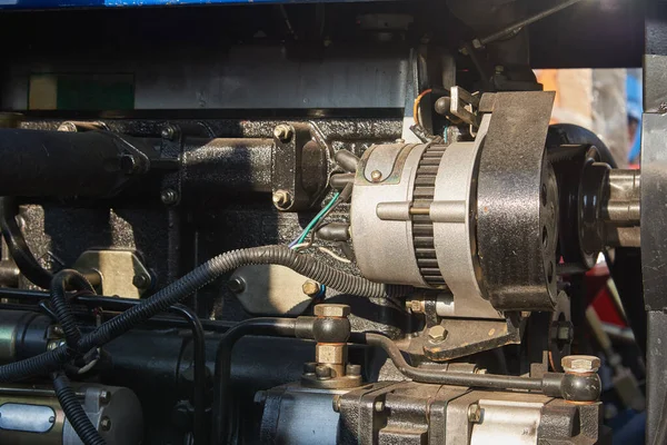 DC generator in the engine compartment of the mini tractor