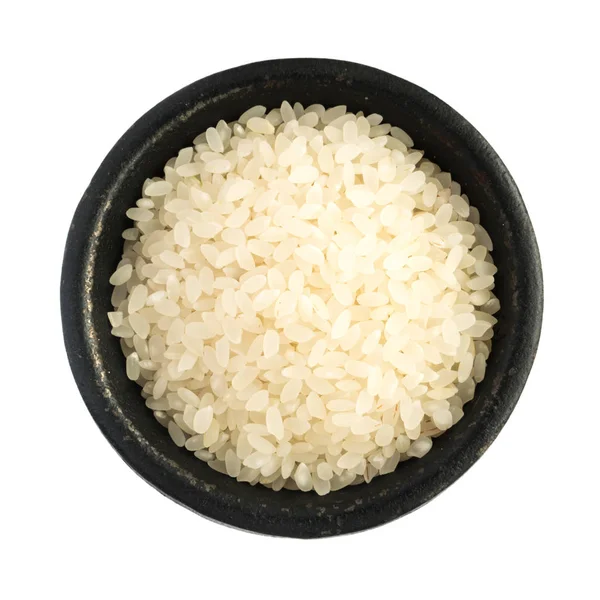 Grãos de arroz não cozidos secos brancos Heap na tigela de ferro preto — Fotografia de Stock