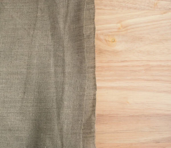 Säckväv kant och trä bakgrund eller gamla linne duk — Stockfoto