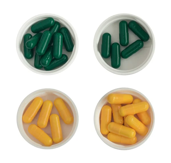 Píldoras y tabletas de medicina farmacéutica en tazas de plástico blanco aisladas — Foto de Stock