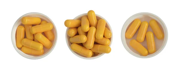Pilules et comprimés de médecine pharmaceutique dans des tasses en plastique blanc isolées — Photo