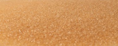 Fotokopi alanına sahip esmer şeker dokusu yığını. Çiğ işlenmemiş kamış şekeri desenli üst görünüm ve düz yatıyordu