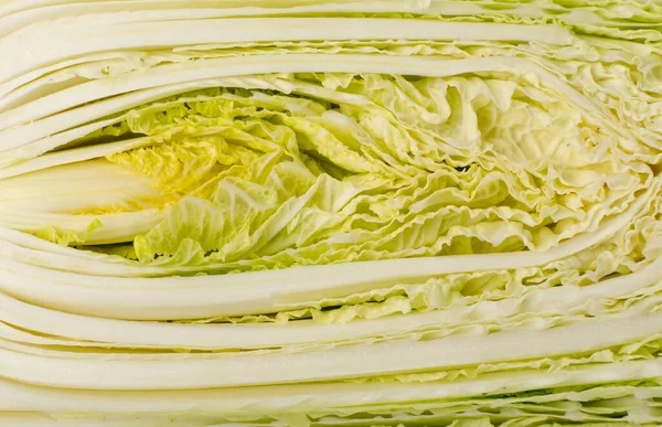 Half of Chopped Chinese Cabbage, Napa Cabbage or Wombok Texture Background. Fresh Green Sliced Cabbage Salat Pattern