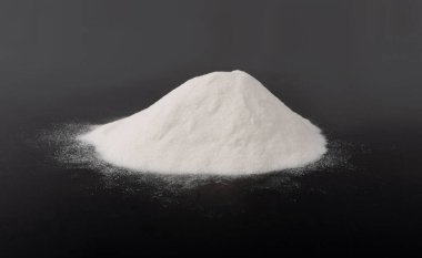 Heap of White Powder of Baking Soda, Clay or Bentonite on Black Background. Powdered Chemicals as Calcium, Gypsum or Plaster Side View clipart