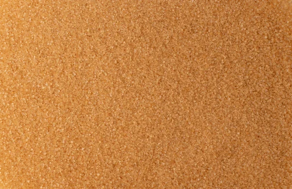 Pile of brown sugar texture background with copy space. Raw unrefined cane sugar pattern top view and flat lay