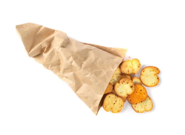 Homemade crunchy croutons in paper bag isolated on white background. Round spicy bruschetta crackers, seasoning rusks or small fried bread snacks top view — Stock Image Homemade Crunchy Croutons Paper Bag Isolated White Background Spicy Bruschetta Stock Image