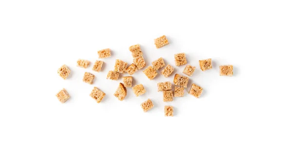 Scattered pile of homemade rye bread croutons isolated on white background top view. Crispy bread cubes, dry rye crumbs, rusks, crouoton or brown roasted crackers cube — Stock Image Scattered Pile Homemade Rye Bread Croutons Isolated White Background Top Stock Photo