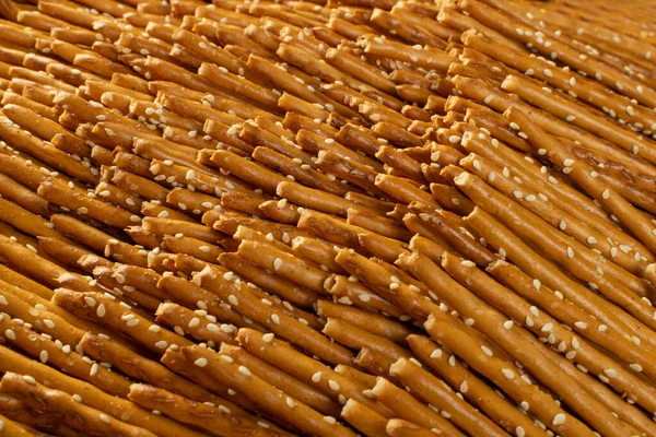 Salt sticks texture background with copy space. Salty pretzel sticks flat lay pattern, grissini wallpaper or thin breadsticks mockup