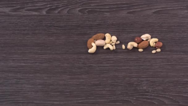 The cardiogram and heart made of nuts. The beating of the heart and the construction schedule cardiogram. Stop motion — Stock Video