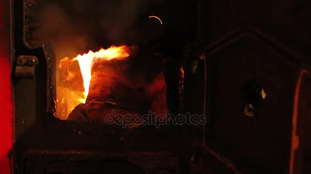 Quemando troncos en la estufa. Cerrando la puerta de la vieja estufa . — Vídeos de Stock