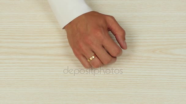 Hands of a man taking a ring off his finger. Top view — Stock Video