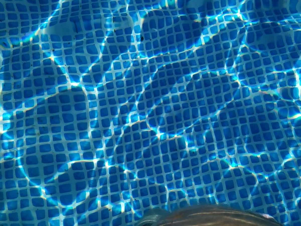 Reflective water surface of a swimming pool.