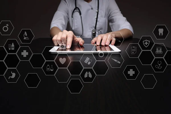 Medicine technology and healthcare concept. Medical doctor working with modern pc. Icons on virtual screen.