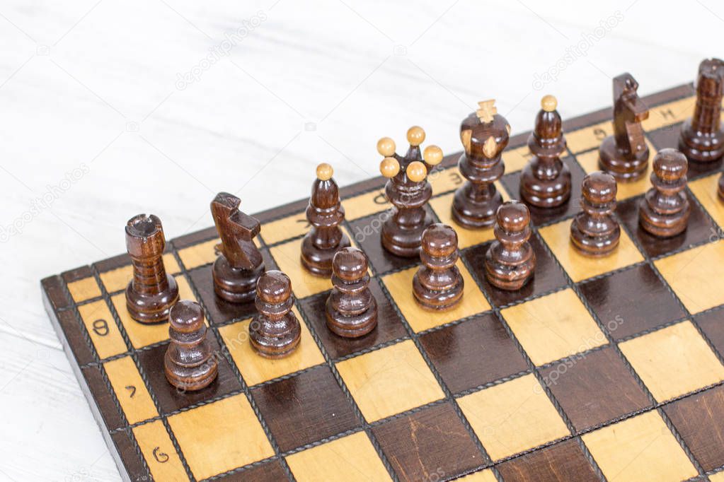 Top view of wooden chess pieces before battle.
