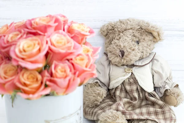 Roses in a round box and plush bear. Romantic gift.