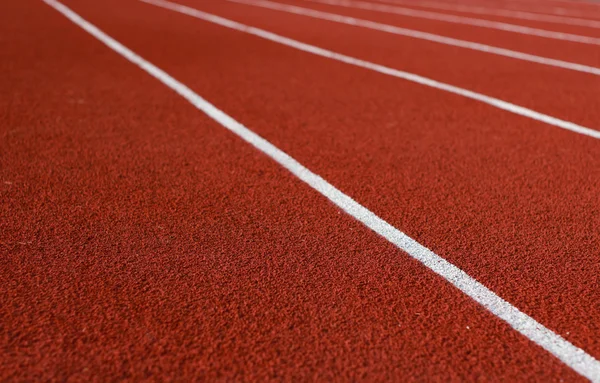 Line running track around the football field with the evening sun