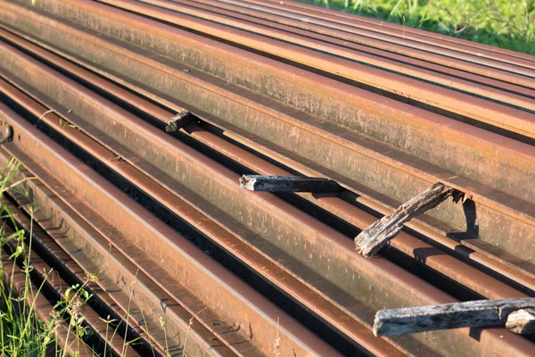 Steel tracks piled together beside — Stock Photo, Image