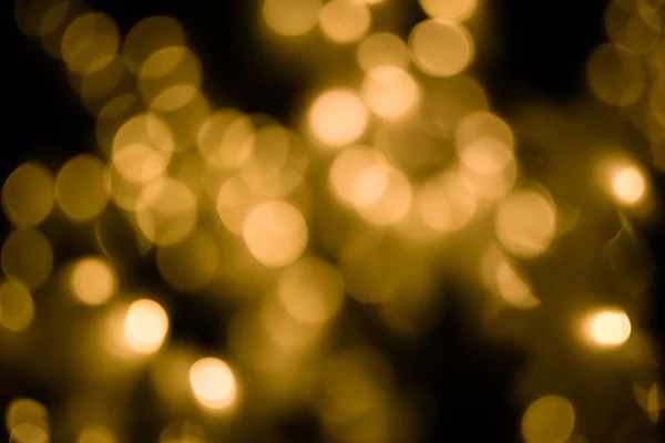 Bokeh luz oro desenfoque en fondo abstracto noche . — Foto de Stock