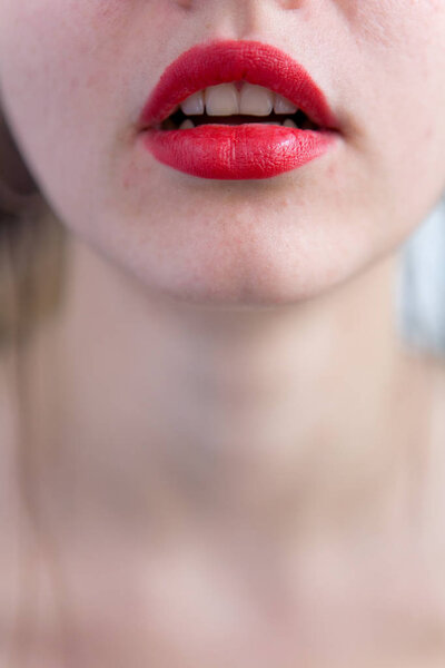 Sexy slightly opened lips of the girl on which red lipstick is a