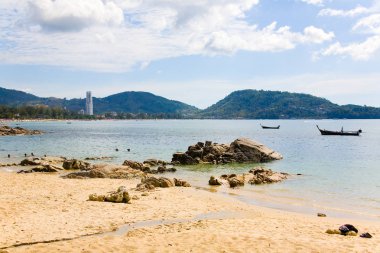 Plaj, yüksek katlı bina ve düşük gelgit tekneler görünümünü.