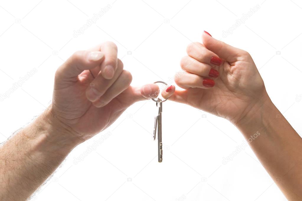 Male and female hands hold a bunch of keys.