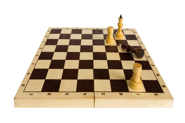 Black King dał i leży na szachownicy. — Zdjęcie stockowe