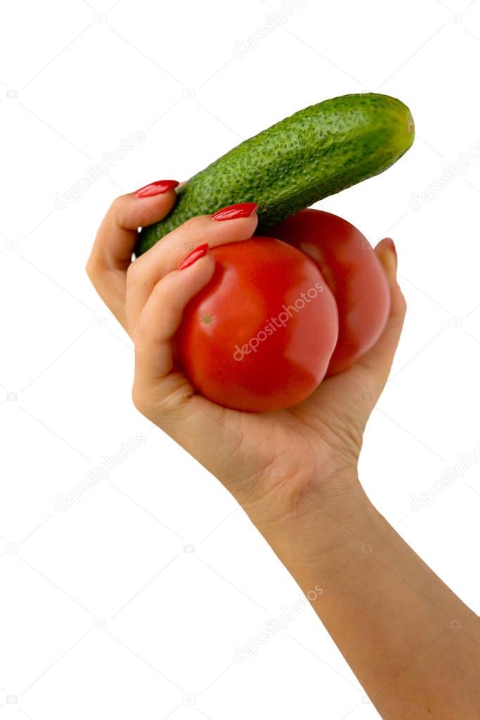 A beautiful female hand holds vegetables.