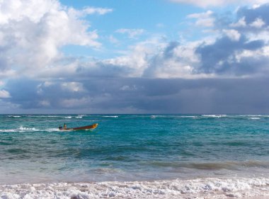 Bir adam bir sarı tekne sürücüler.