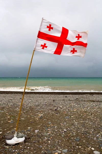 The Georgian flag is flying in the wind.